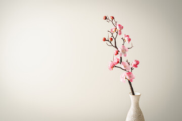 Wall Mural - Spring flowers in glass vase still life. Blooming cherry branch on pink background. Simple minimalist home decor. Space for text