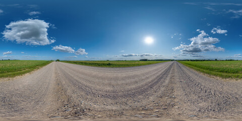 Wall Mural - 360 hdri panorama on gravel road with marks from car or tractor tires with clouds on blue sky in equ