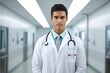 © JMDuran Photography - Young latin american doctor with white coat and a stethoscope on his shoulder standing on a hospital corridor