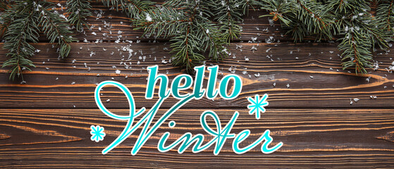 Wall Mural - Banner with text HELLO WINTER and Christmas tree branches on wooden background