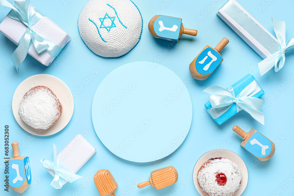 Festive composition with blank greeting card and Hanukkah symbols on blue background