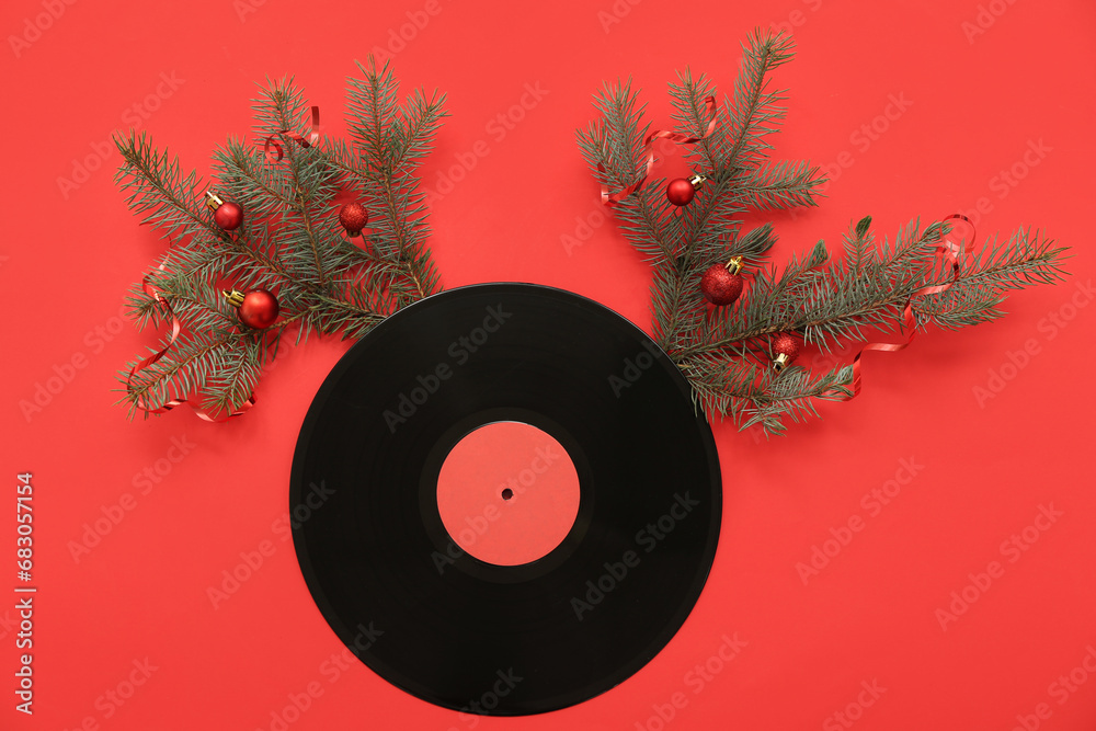 Vinyl disc with Christmas decor on red background