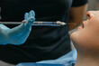 Anesthesia in dentistry. Anesthetic before dental treatment. Anesthetic in a syringe in front of the patient's mouth