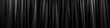 Soft black curtain, folding vertically from top to bottom, close-up