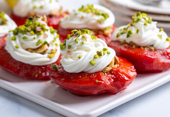 Wall Mural - Traditional Turkish style quince dessert. The quince is cooked until soft, sherbet is poured on it, and served with cream and walnuts. It is one of the most popular Turkish desserts.(Ayva Tatlisi)