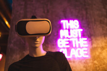 Mannequin With VR Headset In Neon-Lit Room