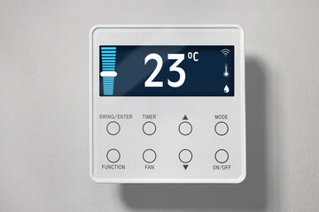 Canvas Print - Thermostat displaying temperature in Celsius scale and different icons. Smart home device on light wall