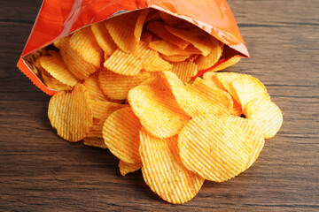 Potato chips in open bag, delicious BBQ seasoning spicy for crips, thin slice deep fried snack fast food.