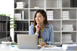 © Kainnika - Portrait of an attractive Asian businesswoman in the office.