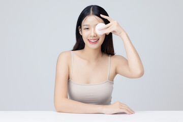 Attractive young Asian woman smile and uses cotton pad with toner for cleaning make up feeling so fresh and clean with healthy skin, isolated background.