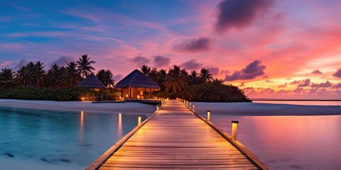 Wall Mural - Sunset on Maldives island, luxury water villas resort and wooden pier. Beautiful sky and clouds and beach background for summer vacation holiday and travel concept