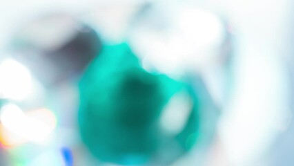 Wall Mural - Shine of Graceful Emerald Facets. Loop. The light passes through the facets of a slowly rotating diamond and creates repetitive sparkling highlights and rainbow colors