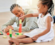 © Irshaad Majal/peopleimages.com - Family on the floor, mother and girl with blocks, playful and fun with happiness, weekend break and relaxing. Mama, apartment and kid with child development, home and building tower with wooden toys