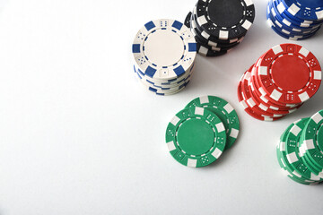 Wall Mural - Stacks of colorful casino chips on white isolated table