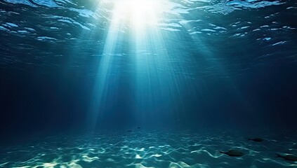 Wall Mural - Submerged serenity. Tranquil underwater scene with sun rays and clear blue ocean. Sunlit depths. Abstract background with bright sunbeams and clear sea