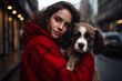 Portrait of a young woman hugging a dog outdoor in street 