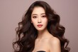 © Viewvie - Beautiful Asian woman with long curly hair and perfect skin with makeup, facial treatment, beauty, plastic surgery.