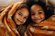 Funny cute two children wrapped in warm blanket enjoy spending time together Generative AI picture