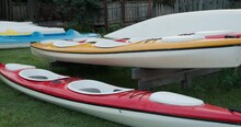 Multicolored Kayaks Stands On A River Bank, Rent Of Water Transport.