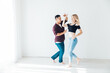 © dmitriisimakov - Couple dancers man and woman dancing in studio workout