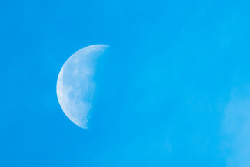 moon during the day against the blue sky