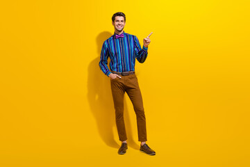 Poster - Full body photo of handsome man wear bow tie stylish shirt indicating at proposition empty space isolated on yellow color background