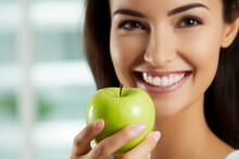 A Woman Holding An Apple In Front Of Her Face