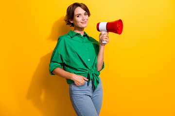 Canvas Print - Photo of funky good mood girl dressed green shirt rising toa empty space isolated yellow color background