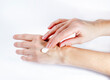 © Elena - Close-up of woman applying protective cream to her hands. Hand skin protection during the cold season, hand care