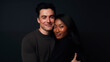 An international couple, an African-American woman and a European-looking man. Portrait of a happy interracial couple on a gray background. Love