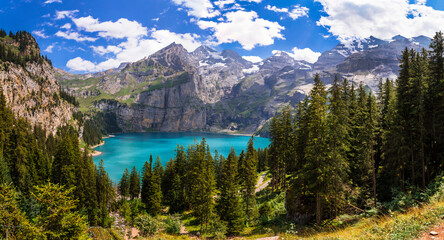 Sticker - Idyllic swiss mountain lake Oeschinensee (Oeschinen) with turquise water and snowy peaks of Alps mountains near Kandersteg village aerial high angle view. Switzerland nature scenery