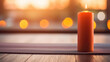 Closeup of a lit candle casting a warm, orange light on a yoga mat, ready for a peaceful session on the beach.