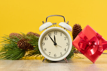 Wall Mural - Alarm clock and stack of red gift boxes on yellow background