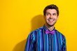 © deagreez - Portrait of pleasant nice guy dressed stylish shirt bow tie look at proposition empty space isolated on bright yellow color background