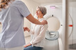 Cropped view of the female doctor calming senior patient woman before the MRI scanning