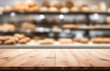 Empty wooden table top in focus, blurred bakery background. Blank desk for advertising product, generated by AI