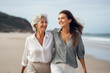 © piksik - mother's day concept. adult daughter and her senior mom walking at the seaside