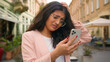 © Yuliia - Young hoping Indian Arabian woman businesswoman lady female tourist looking at mobile phone worried stressed upset frustrated girl smartphone mistake error in city problem job failure loss bad news