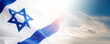 Banner with Official flag of Israel on with blue sky on background and empty space for text. Israeli flag for Jewish Holidays and independence day.