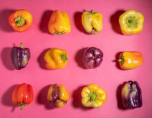Grid Of Colorful Bell Peppers On Pink