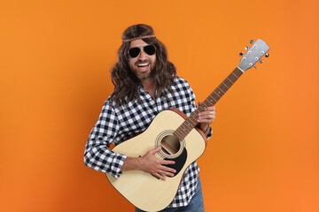 Sticker - Hippie man in sunglasses playing guitar on orange background