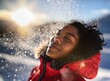 Portrait of black African teenager, teen enjoy snowfall on winter holiday, smiling in the snow