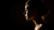 © FlyStun - Visage d'une jolie femme de profil dans le noir. Femme, silhouette, gros plan, sur fond noir. Pour conception et création graphique