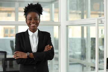 Canvas Print - Happy woman with crossed arms in office, space for text. Lawyer, businesswoman, accountant or manager