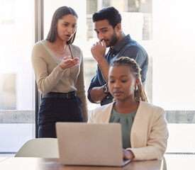 Canvas Print - Office bully, woman and working at laptop with coworkers talking in a corporate workplace with gossip. Young black person typing on a computer with internet and joke with staff being mean at desk