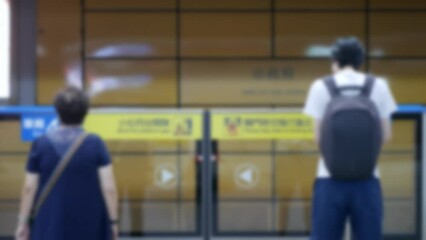 Wall Mural - out of focusing blur view of passengers traveller waiting for arrival train and get on subway train 