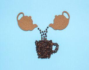 Coffee beans are poured from two teapots into a cup of beans.