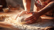 Close-up of baker's hands covered in flour kneading dough. Baker preparing dough for baking.