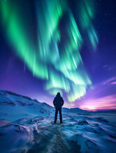 Man Looks Up In Wonder As He Watches The Amazing Aurora Borealis Northern Lights Dance Across The Sky At Night