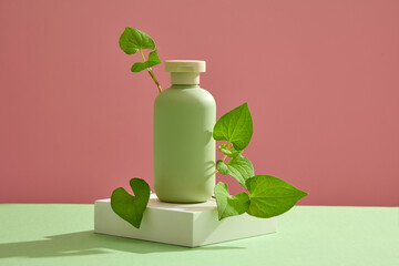 Wall Mural - A white podium with empty label bottle and some fish mint leaves placed on. Cosmetic package mock up collection for cream, foams, shampoo extracted from Fish mint